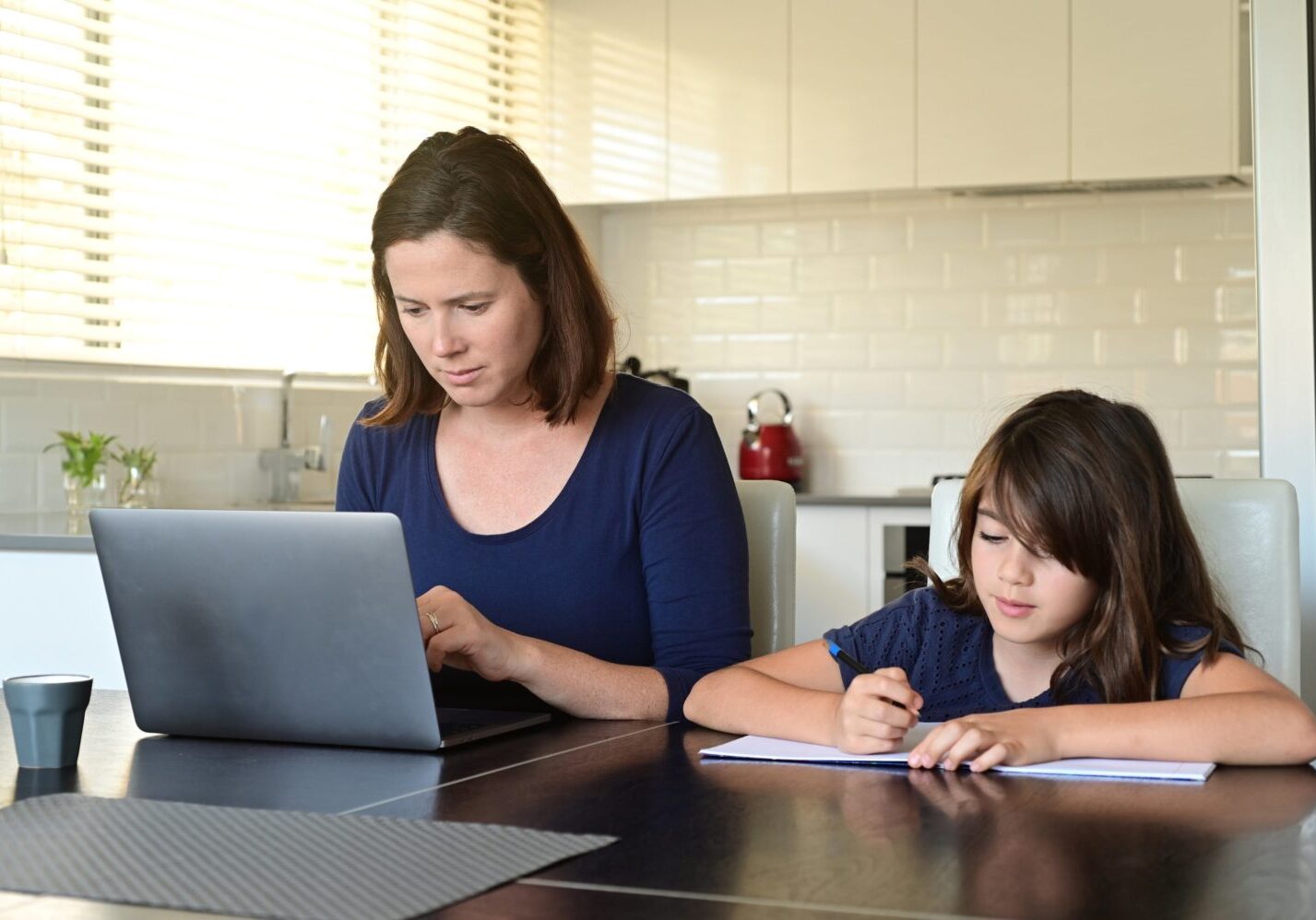 Mother working from home with Daughter