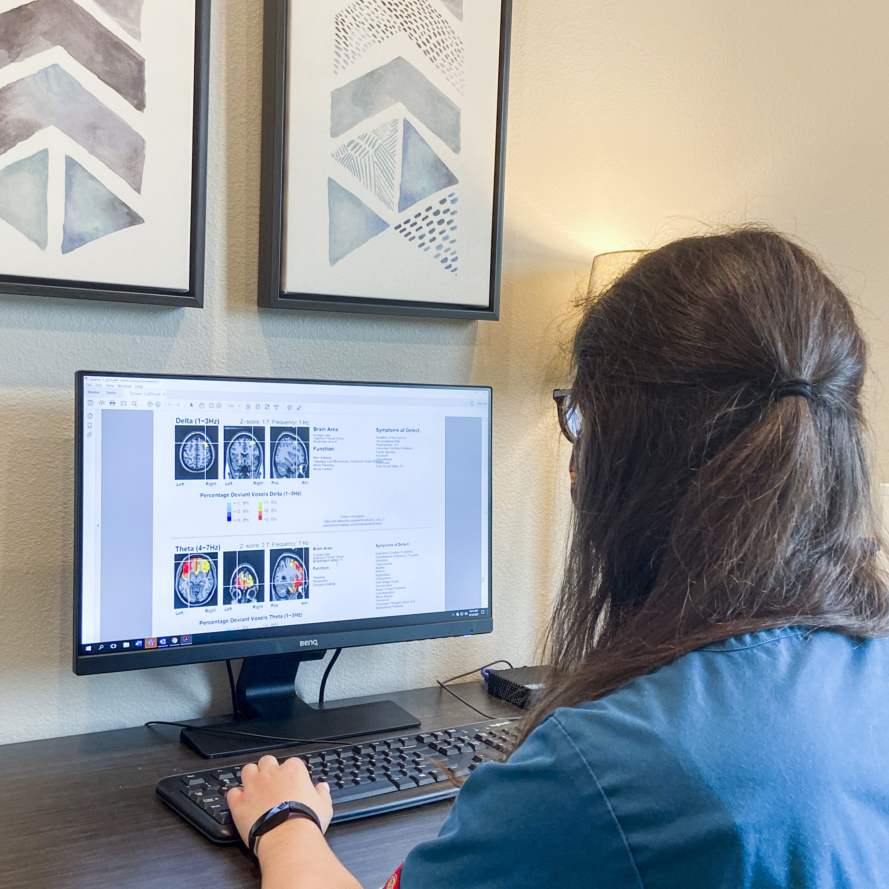 Close up of our qEEG Technician reviewing results from a patient's test