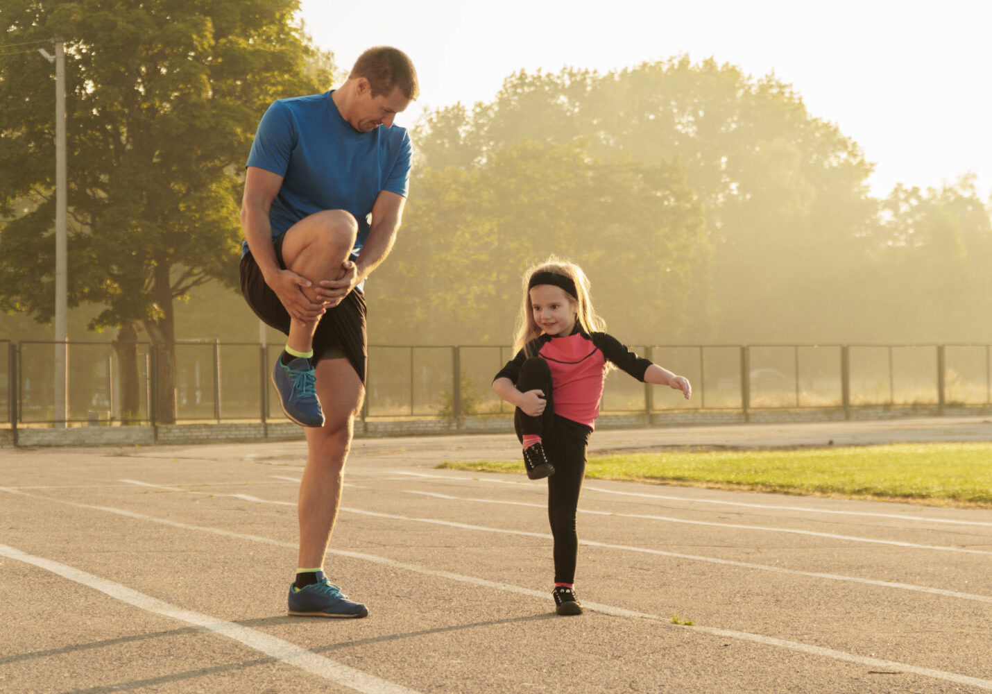A Father and his daughter stretching before a workout